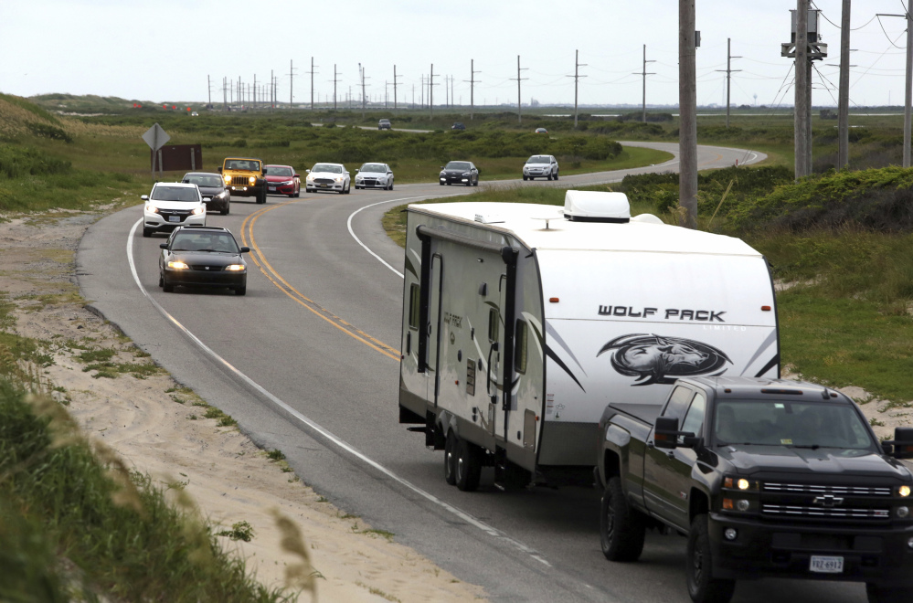 Vacationers depart Hatteras Island on Friday after a power outage caused by a construction crew accidentally driving a steel casing into an underground transmission line. 