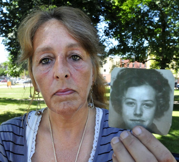 Honey Rourke, 53, of Lewiston holds a photograph of her mother, Pauline Rourke, taken in 1970. Honey was just 12 when her mother disappeared in 1976. Albert P. Cochran, 79, a convicted murderer who told police he knew the location of Pauline Rourke's remains, died last month in a Rockport hospital while serving a life sentence.
