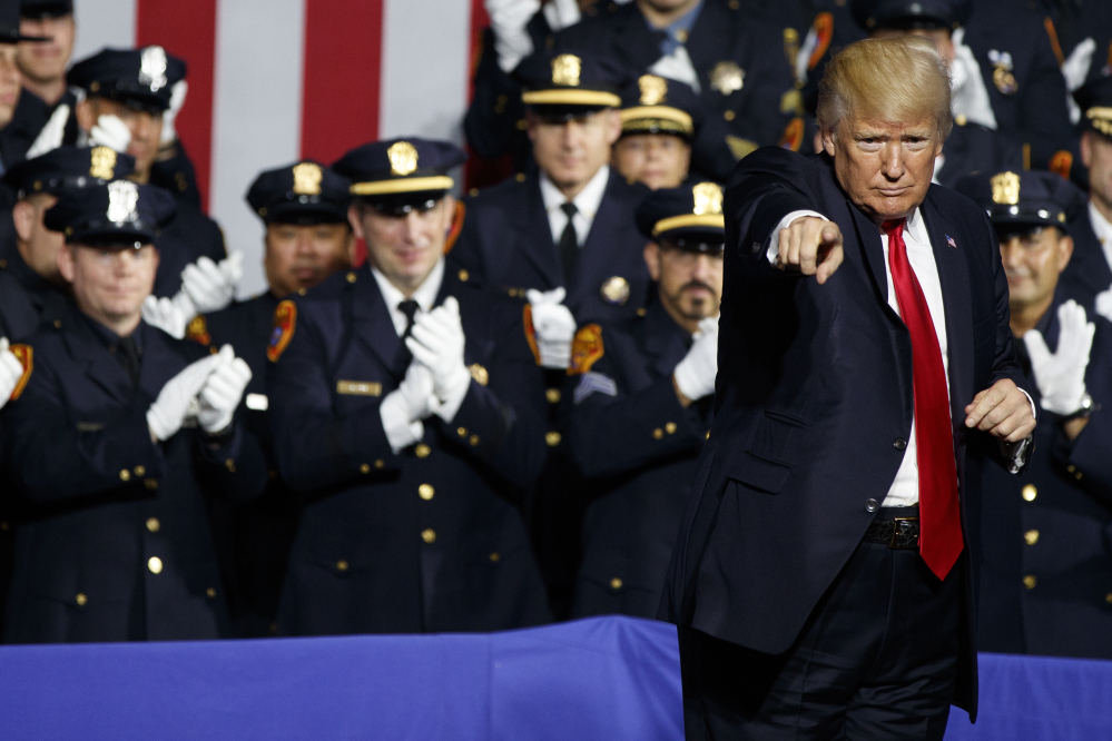 President Trump engages with a crowd of law enforcement officials Friday in Brentwood, N.Y.: "When you guys put somebody in the car and you're protecting their head," he told them, "... you can take the hand away, OK?"