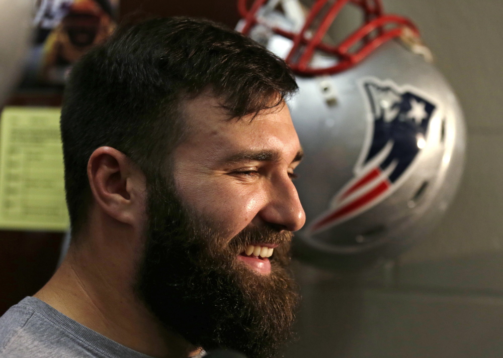New England defensive end Rob Ninkovich smiles as he answers a reporter's question in the locker room before practice in 2014.