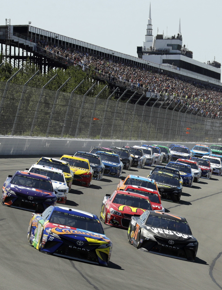 Kyle Busch (18) leads the field into Turn 1 at the start of the Cup Series race Sunday at Pocono Raceway.