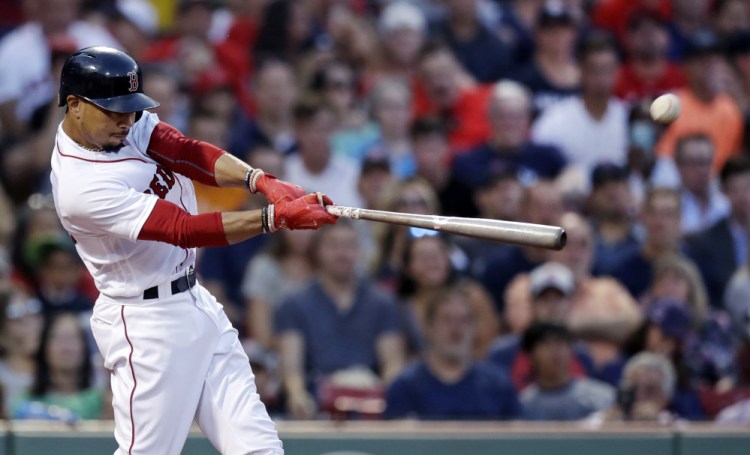 Mookie Betts connects for a two-run single in the second inning of Monday night's game against Cleveland. He finished with two hits and three RBIs in the game.