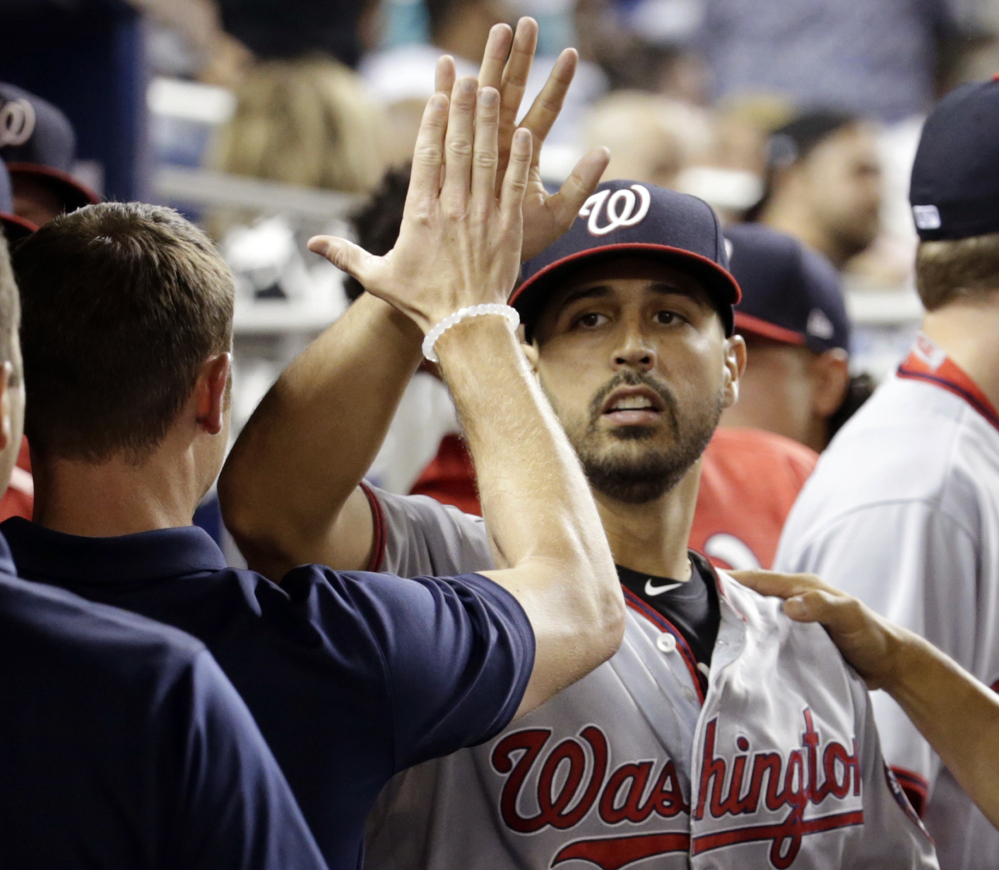 Nationals pitcher Gio Gonzalez is high-fived in the dugout after being relieved during the ninth inning against the Miami Marlins on Monday in Miami. Gonzalez gave up a single to Dee Gordon in the ninth inning to end his bid for a no-hitter.