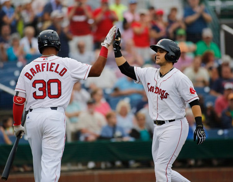 Michael Chavis of the Sea Dogs, right, celebrates with teammate Jeremy Barfield after hitting a home run on July 17 at Hadlock Field. He hit 14 home runs in 67 games with Portland.