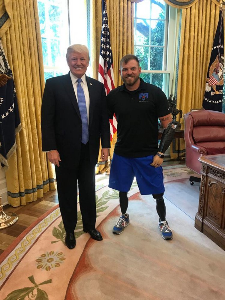 Staff Sgt. Travis Mills, right, poses with President Donald Trump on Monday during a trip to meet with Vice President Mike Pence to discuss veterans' issues.