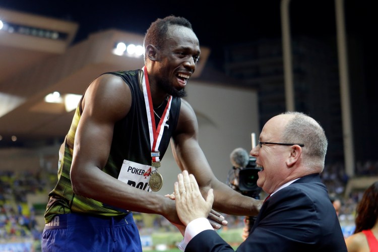 Jamaica's Usain Bolt shares a laugh with Prince Albert of Monaco during the podium ceremony after winning the men's 100 at the IAAF Diamond League Athletics meeting at the Louis II Stadium in Monaco, Friday.