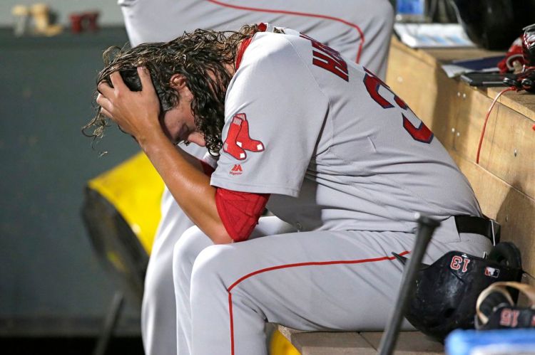 Red Sox pitcher Heath Hembree sits in the dugout after being pulled during the 7th inning of Tuesday night's game against the Seattle Mariners.