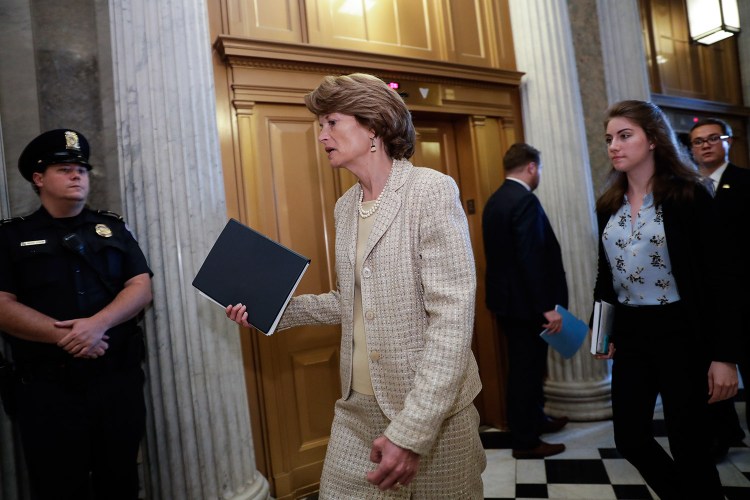 Sen. Lisa Murkowski, R-Alaska, arrives Wednesday for a vote as the Republican-run Senate rejected a Republican proposal to scuttle President Obama's health care law and give Congress two years to devise a replacement.