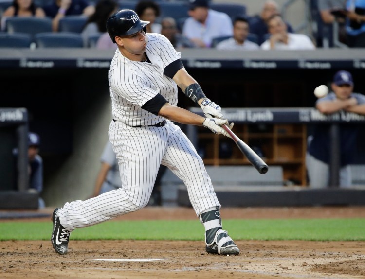 Gary Sanchez of the Yankees hits a solo home run in the third inning against Tampa Bay Thursday night in New York.
