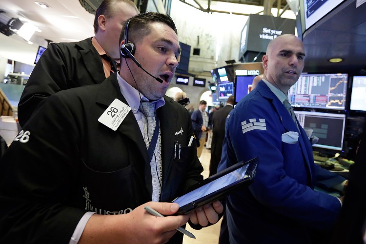 Trader Joseph Lawler, left, and specialist Philip Finale work on the floor of the New York Stock Exchange on Monday.