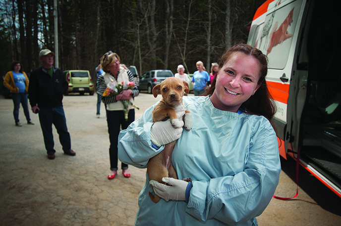 Dr. Mandie Wehr, veterinarian and shelter director for the merged Coastal Humane Society and Lincoln County Animal Shelter, carries Zola during a rescue operation.