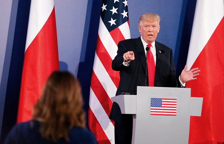President Trump takes part in a joint news conference with Polish President Andrzej Duda in Warsaw Thursday. The event marked the first time Trump has taken questions during an overseas trip.