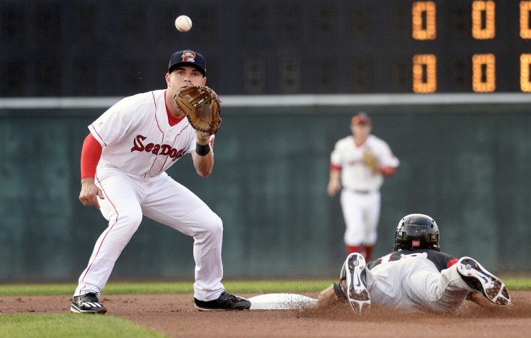 Portland's Chad De La Guerra waits for the throw as T.J. Bennett of the Richmond Flying Squirrels safely slides into second Tuesday at Hadlock Field.