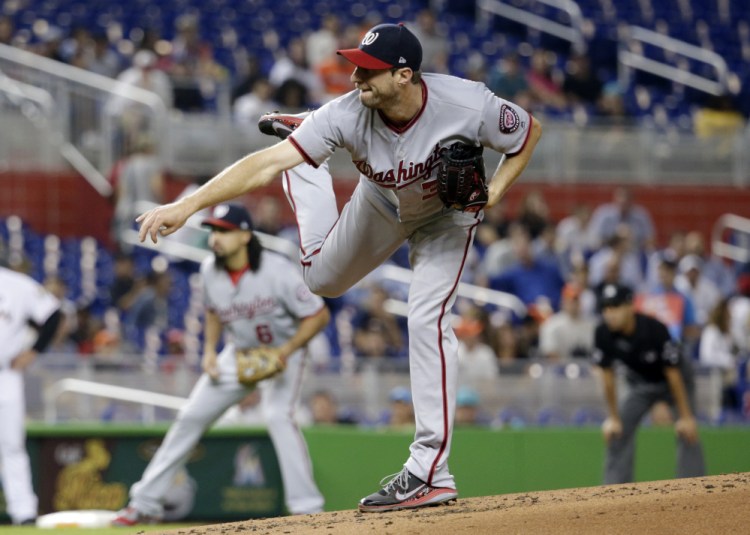 Max Scherzer of the Washington Nationals follows through on a delivery in the first inning Tuesday night. Scherzer left the game as a precaution before the second with a neck spasm.