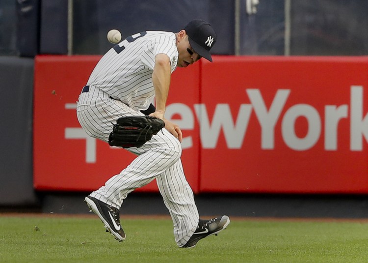 Yankees center fielder Jacoby Ellsbury mishandles a hit by Detroit's James McCann during the fourth inning Wednesday. Ellsbury was charged with an error on the play.