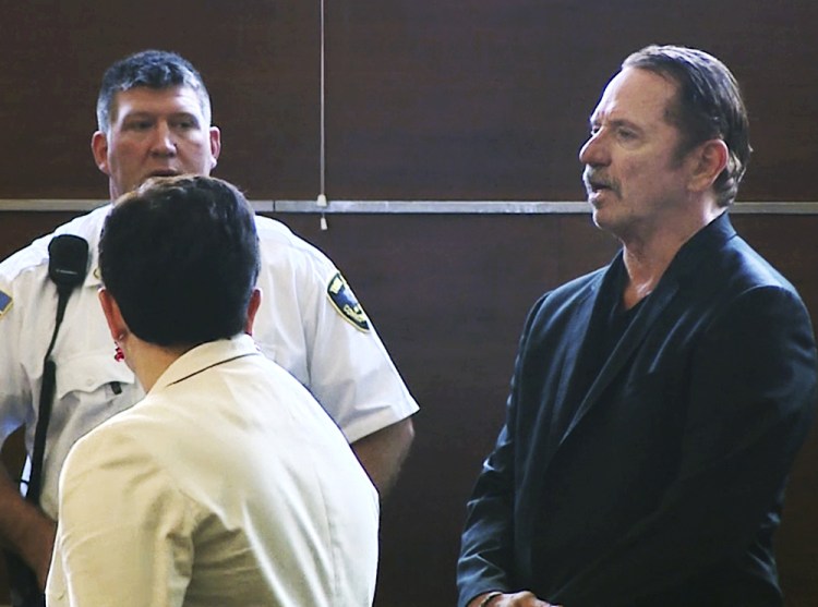 Actor Tom Wopat, right, stands during arraignment Thursday in Waltham, Mass. He was arrested as he was leaving a play rehearsal Wednesday  and is charged with indecent assault.
WCVB-TV via AP, Pool