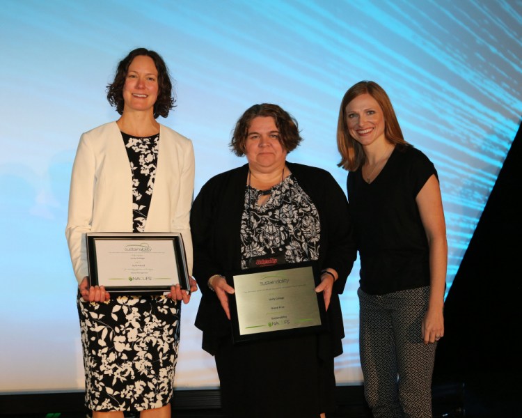 Jennifer deHart, left, chief sustainability officer at Unity College, and Lorey Duprey, middle, director of dining, accept the grand prize for sustainability from a representative of the National Association of College and University Food Services at the group's conference in July in Nashville, Tennessee.