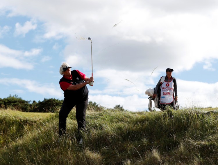 Laura Davies plays out of the rough Thursday during the first round of the Women's British Open at St. Andrews, Scotland. Weather was a factor for Davies, who started 6-under after 14 holes and finished at 68.
