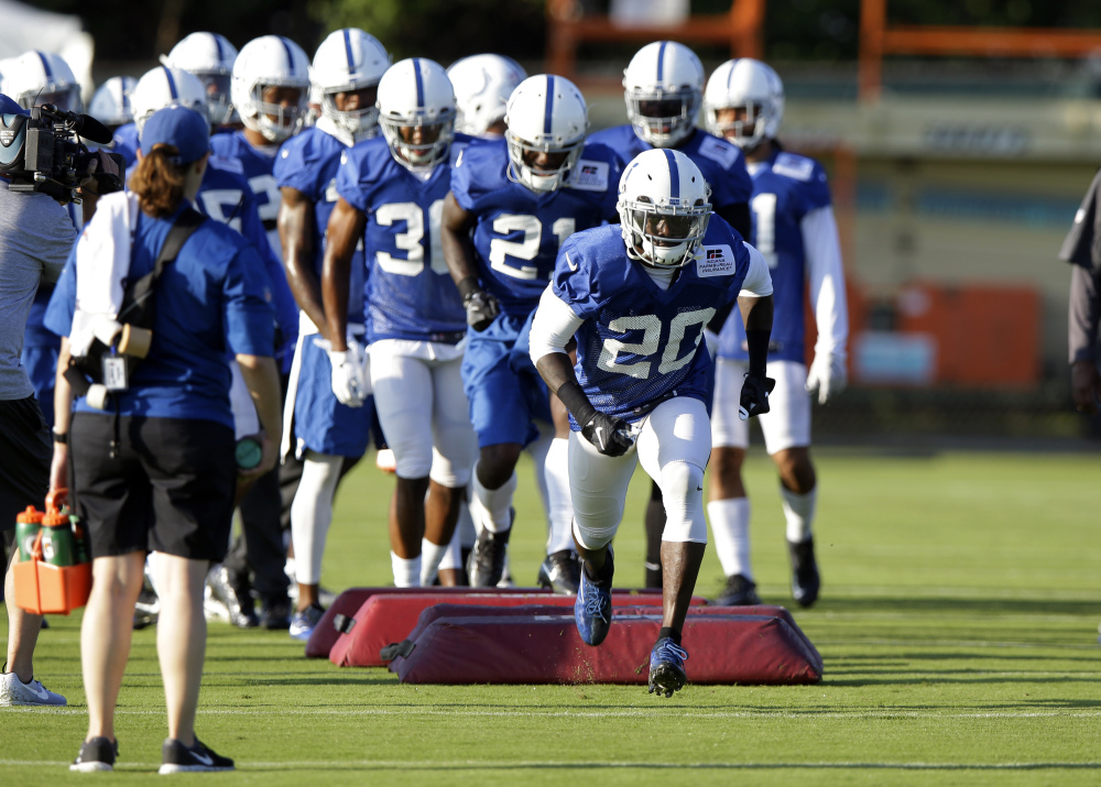 In this July 31 photo, Indianapolis Colts free safety Darius Butler (20) runs over a blocking dummy during practice in Indianapolis.