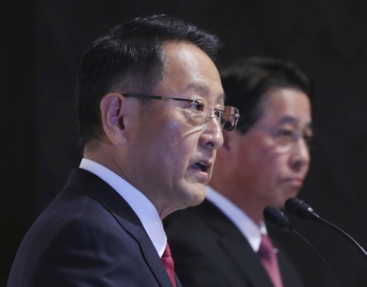 Toyota Motor Corp. President Akio Toyoda, left, and Mazda Motor Corp. President Masamichi Kogai hope to rein in competition from industry newcomers like Amazon, Google and Apple.