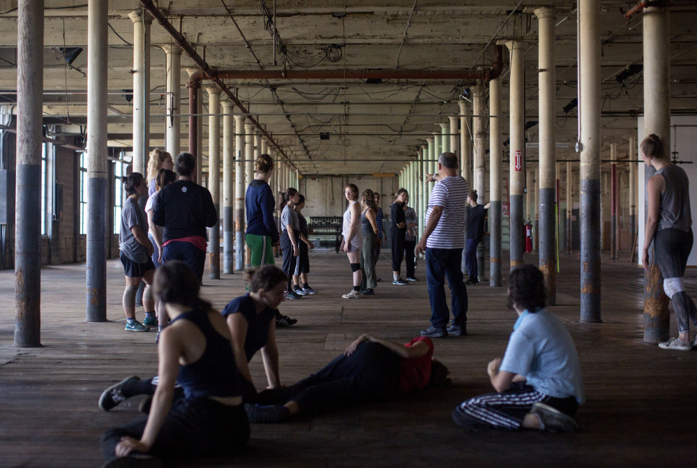 Dancers rehearse the finale of the multimedia production "Mill Town" at the Bates Mill Complex. 
