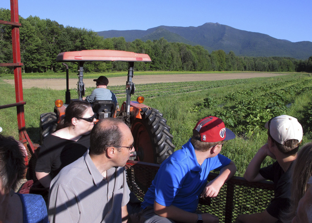 Visitors get a tour of Valley Dream Farm in Cambridge, Vt., before sitting down to eat a weekly dinner featuring produce from the farm and other Vermont-made products.