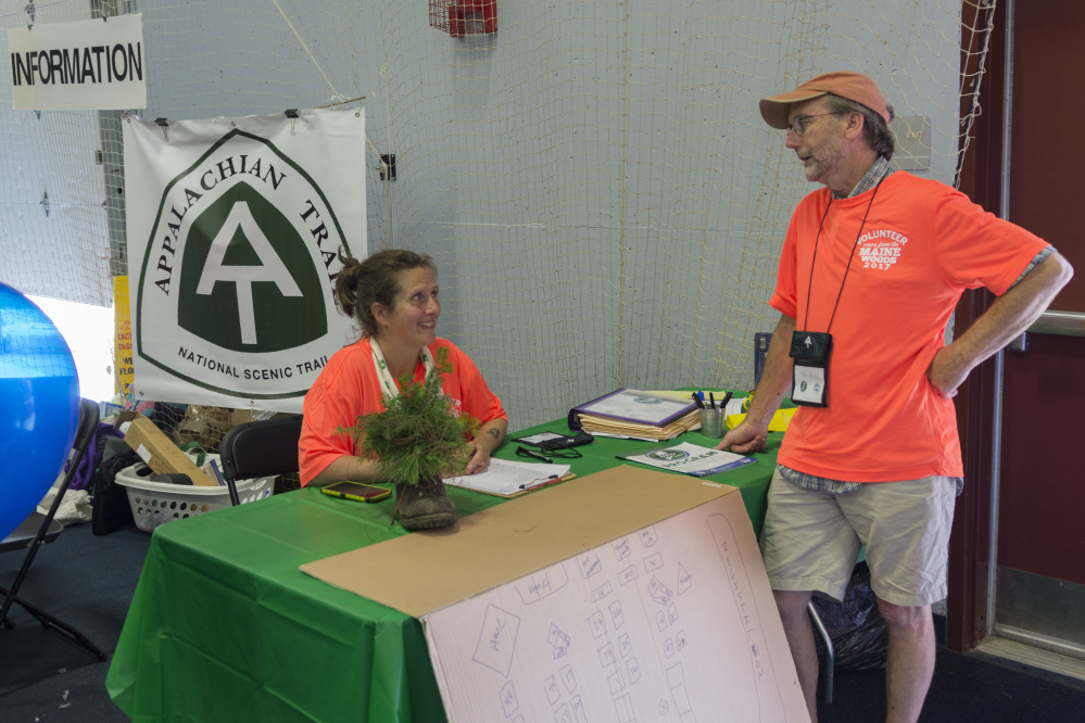 Holly Sheehan, who manages the Maine Appalachian Trail Club's Caretaker & Ridgerunner Education Program, and Tony Mullin confer during registration Friday at the Appalachian Trail Conservancy Conference at Colby College in Waterville. Sheehan and Mullin provided directions to participants arriving at the conference.