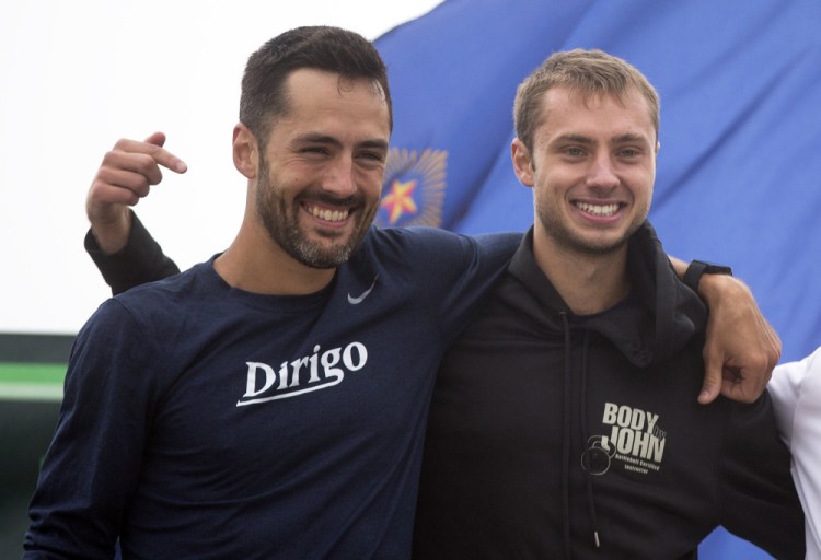 Jesse Orach, right, who finished first in the Beach to Beacon among Maine men with an assist from Rob Gomez, left: "I'm speechless with what he did."