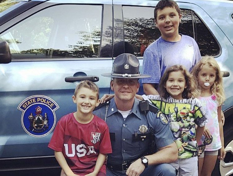 Trooper Nathan Jamo reunites for the first time in six years with four children whom he stood guard over while police searched for their mother's killer. The kids in the front are, left to right, Javanni, Jiselle and Julissa. Ja'kai is in the back.