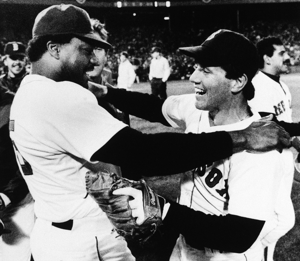Boston Red Sox second baseman Marty Barrett, right, and designated hitter Don Baylor embrace after their team won the AL championship over the California Angels 8-1 at Fenway Park, Wednesday, Oct. 16, 1986, Boston, Mass. Barrett was named Most Valuable Player of the seven game championship series. (AP Photo/Peter Southwick)