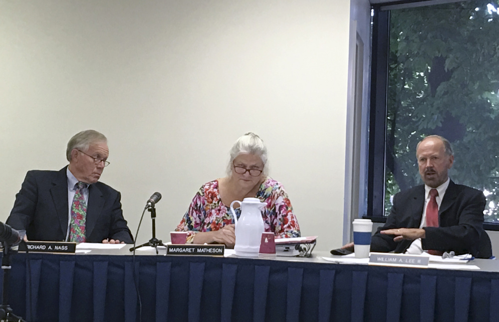Maine Ethics Commission members, from left, Richard Nass, Margaret Matheson and William Lee discuss the investigation of the financing of the campaign for a York County casino on Thursday in Augusta.
