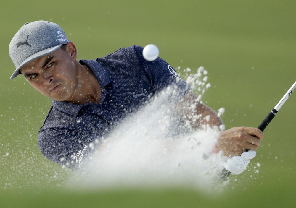 Rickie Fowler hits from the bunker on the 16th hole Thursday during the first round of the PGA Championship. Fowler, seeking his first major title, is two shots back after a 69.