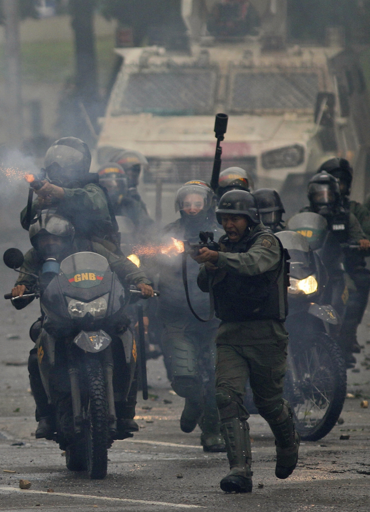 Venezuelan troops fire rubber bullets at anti-government protesters in Caracas last month.