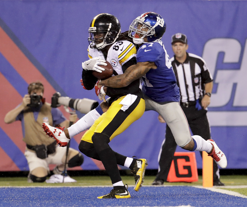 Cobi Hamilton of the visiting Pittsburgh Steelers pulls in a touchdown pass while defended by Valentino Blake of the New York Giants during the second quarter of Pittsburgh's 20-12 victory in an exhibition opener Friday night.