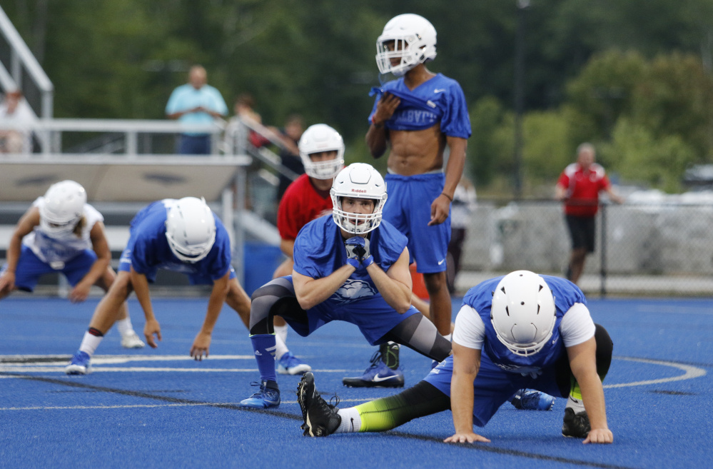 More than 70 players hit the field to stretch and get the program started at UNE. The night practice capped a day of arrivals and adjustment meetings.
