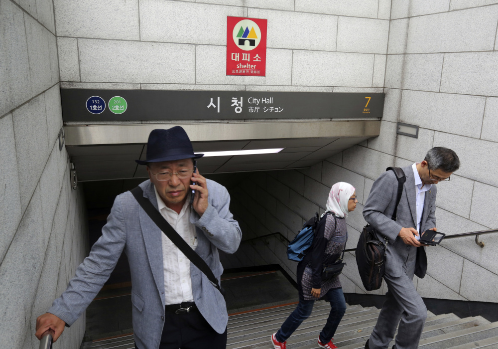 A shelter sign is displayed in case of a possible North Korean attack at the entrance to a subway station in Seoul, South Korea, on Saturday.