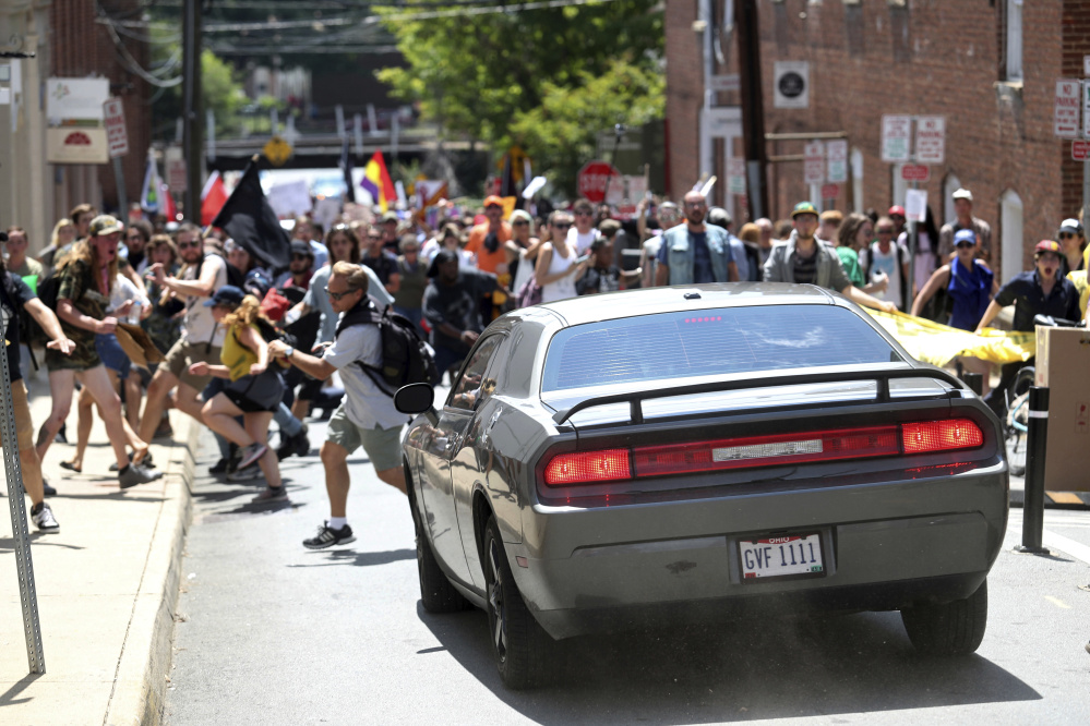 A vehicle plows into a group of protesters demonstrating against a white supremacist rally in Charlottesville, Va., on Saturday. The white nationalists were holding the rally to protest plans by the city of Charlottesville to remove a statue of Confederate Gen. Robert E. Lee.