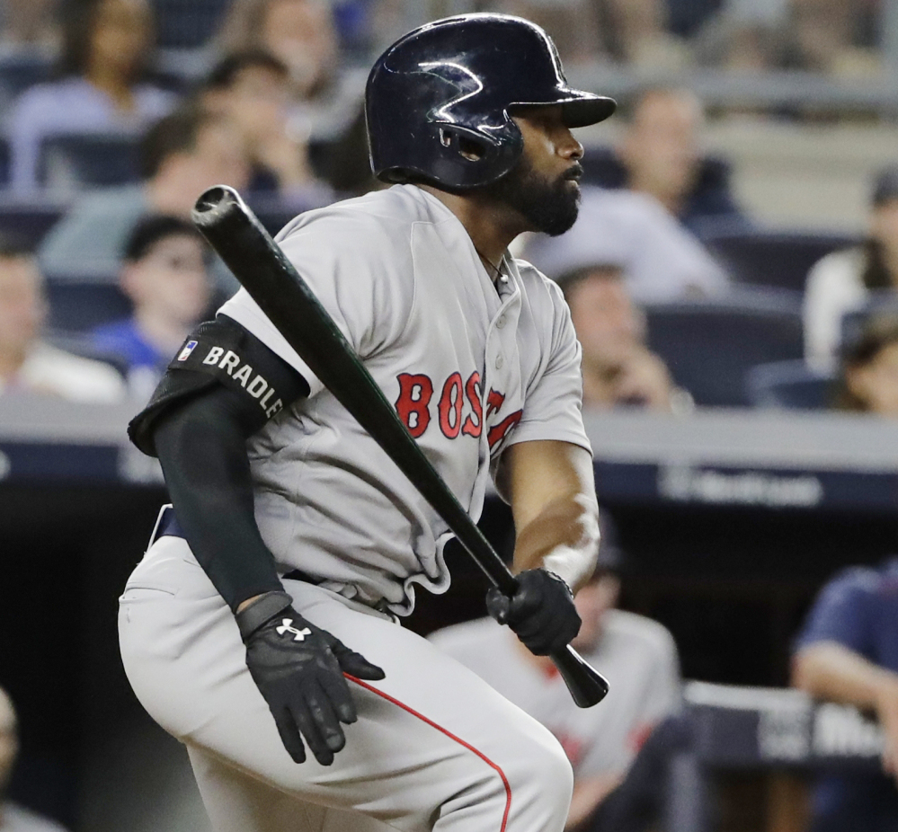 Jackie Bradley Jr. hits an RBI single in the fifth inning Sunday night against the Yankees. Bradley later scored the winning run in the 10th inning.