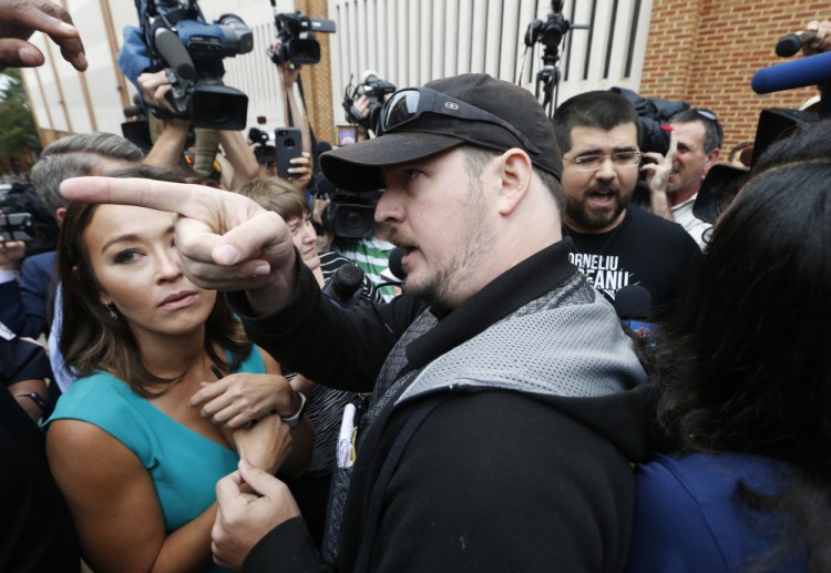 An unidentified man voices his displeasure at the media after a court hearing for James Alex Fields Jr. in front of court in Charlottesville, Va., on Monday. A judge has denied bond for Fields, who is accused of plowing his car into a crowd at a white nationalist rally on Saturday.