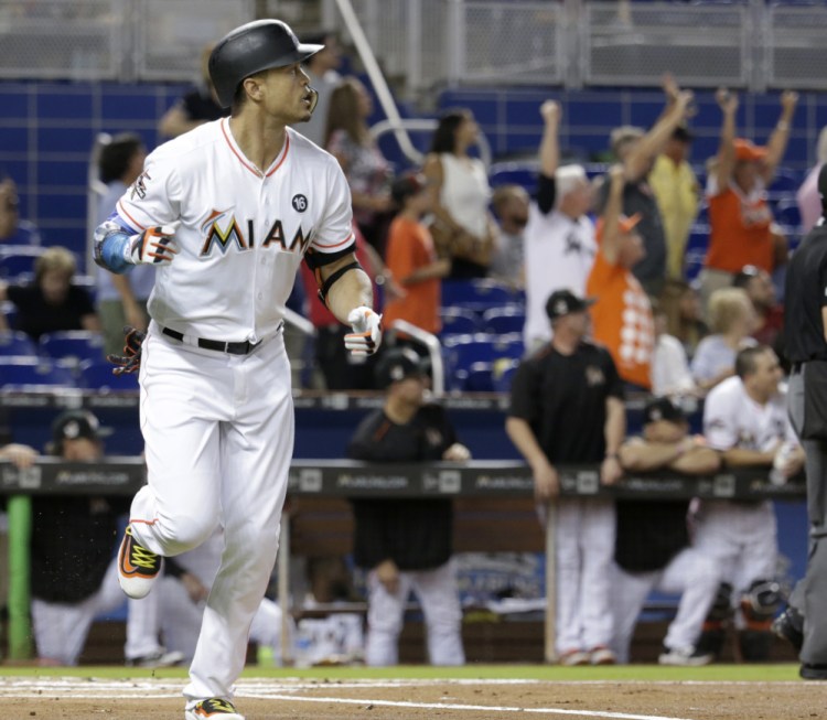 Giancarlo Stanton of the Marlins watches after hitting a two-run homer in the first inning of Miami's 8-3 win at home against San Francisco. Stanton has homered 22 times in 34 games and this one gave him the club record for a season – and it's only mid-August.