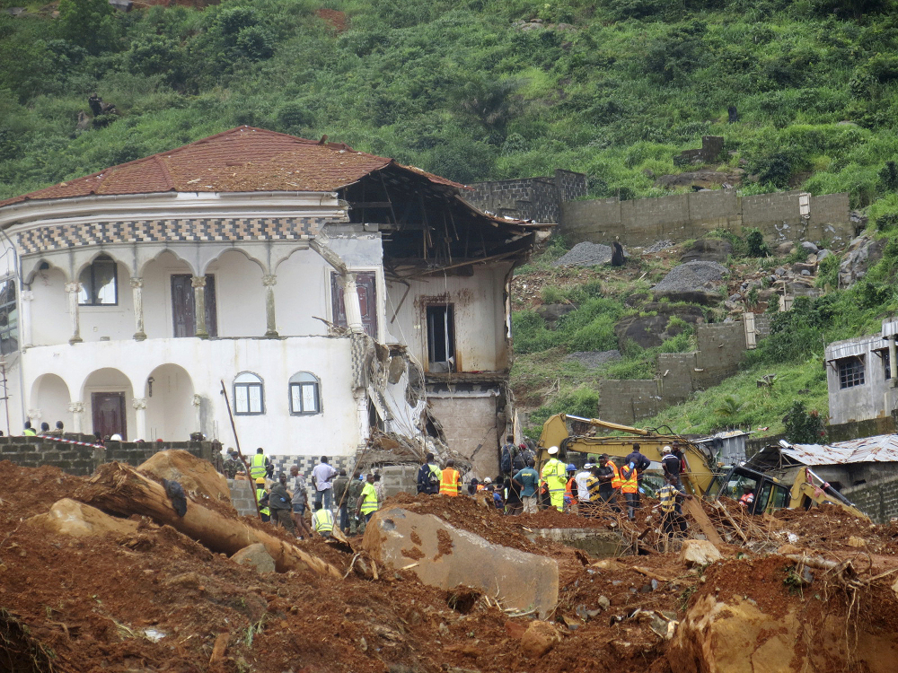 Volunteers search for bodies at the scene of heavy flooding and mudslides in Regent, just outside of Sierra Leone's capital of Freetown. Survivors of deadly mudslides in Sierra Leone's capital are vividly describing the disaster as President Ernest Bai Koroma says the nation is in a "state of grief."