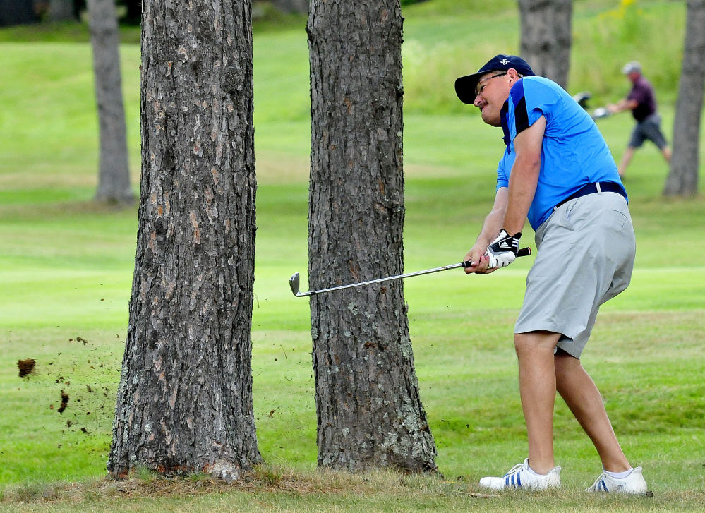 Mike O'Brien chips out of a wooded area during the opening day of the Match Play Invitational on Tuesday at the Waterville Country Club in Oakland.
