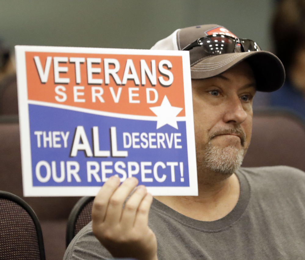 Steve Damron, 50, of Spring Hill, Fla., holds up a sign during a Hillsborough County Commission meeting about possibly moving a Confederate statue.