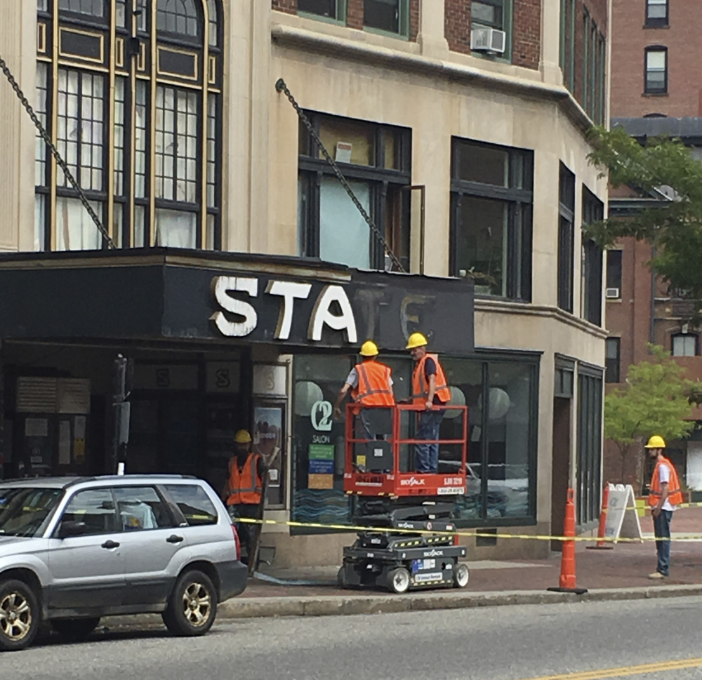 The State Theatre sign is taken down Tuesday. Portland provided a $6,000 facade program grant for the project.