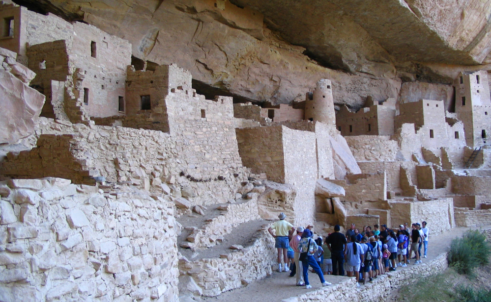 Visitors tour Cliff Palace, an ancient cliff dwelling in Mesa Verde National Park, Colo. Researchers say turkey DNA may be the key to the Pueblo people who disappeared from Mesa Verde of southwestern Colorado 700 years ago.