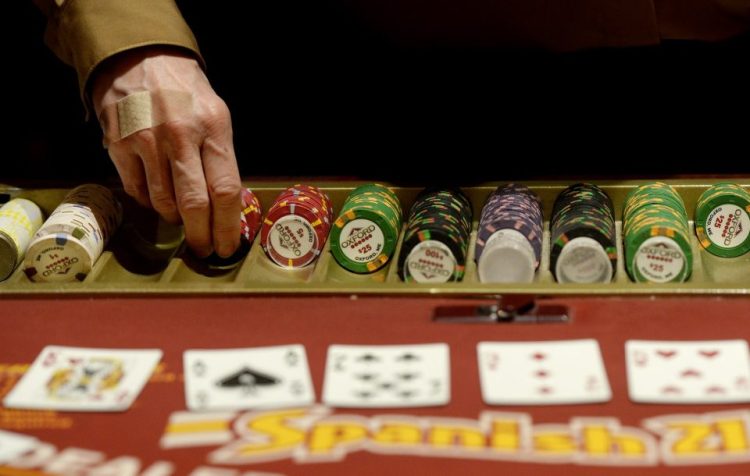 A dealer hands out chips at Oxford Casino in 2013. Maine voters are slated to vote this fall on a referendum to open a York County casino that could be licensed only to Las Vegas developer Shawn Scott; that license is worth an estimated $150 million.