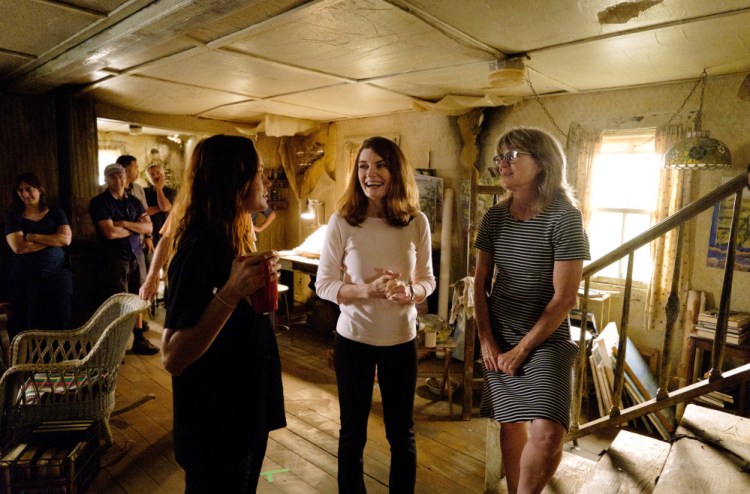 Actress Brie Larson, left, who plays author Jeanette Walls, talks to Walls, center, on the set of "The Glass Castle."