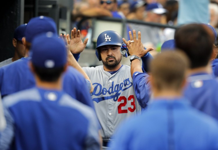 Adrian Gonzalez celebrates after scoring against Detroit in the second inning of the Dodgers' 8-5 road victory Friday night. Gonzalez doubled in first at-bat since June 11.