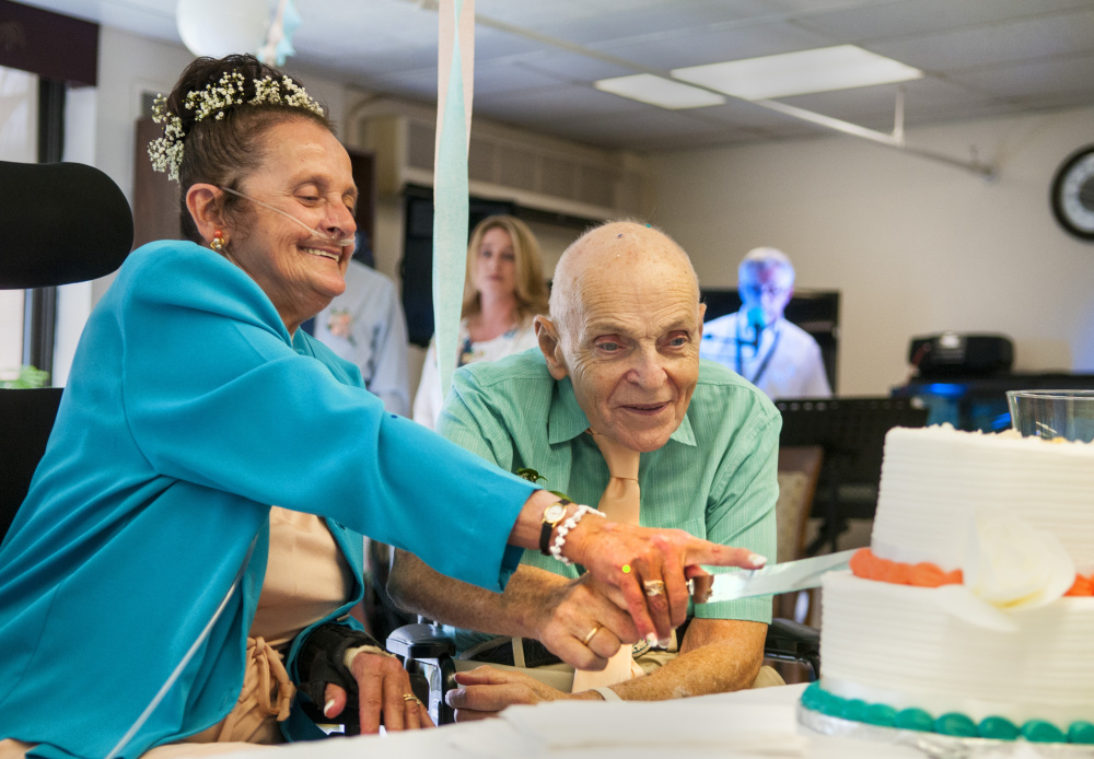 The happy couple, Sonya Trott and Bryant Brunye, enjoy their wedding cake after exchanging vows Saturday afternoon at MaineGeneral's rehabilitation and long-term care facility in Augusta.