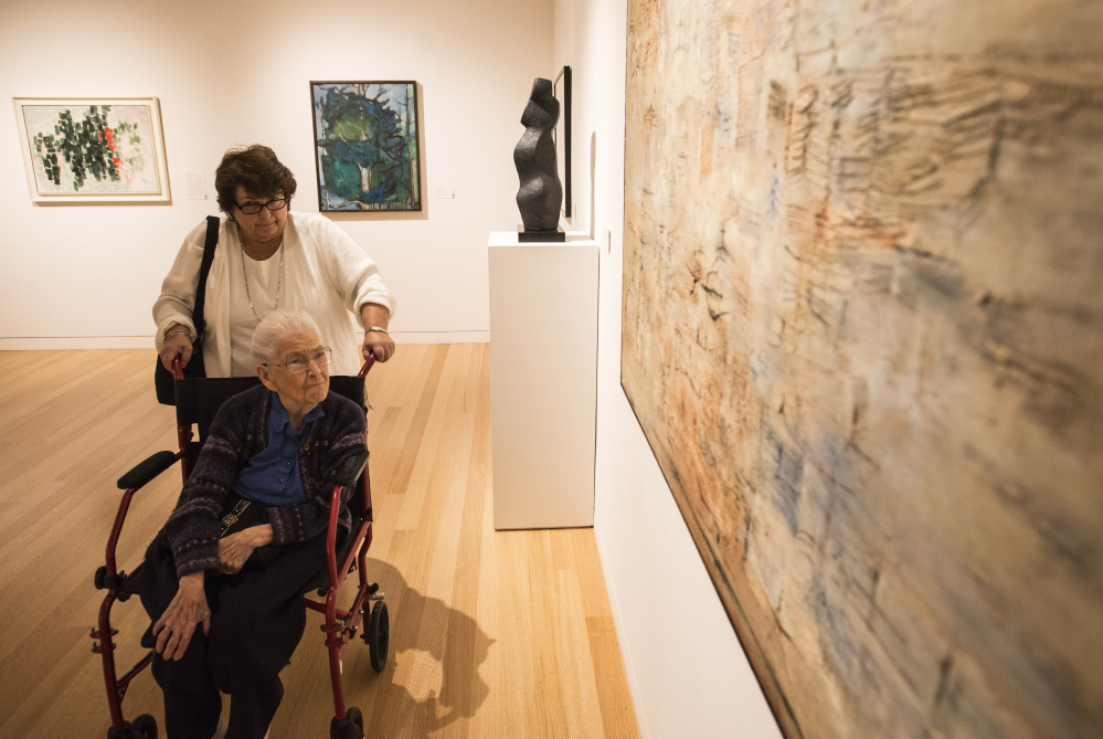 Marion Colby pushes the oldest living member of the Colby clan, Alice Dickinson, 97, during a tour of the Colby College Museum of Art in Waterville on Saturday.